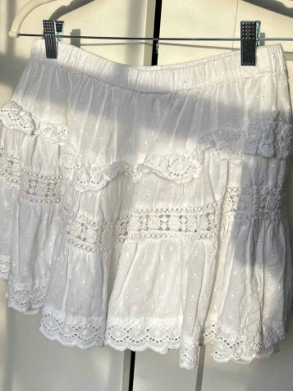 A pure white lace short skirt